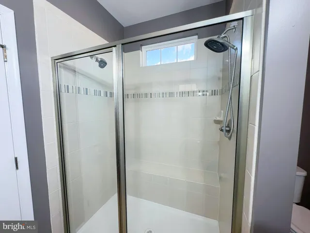 a bathroom with a glass shower door
