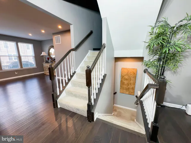 a view of entryway with wooden floor and stairs
