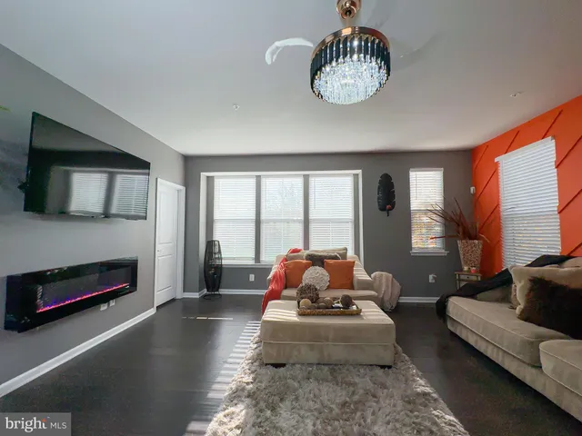 a living room with furniture fireplace and a flat screen tv