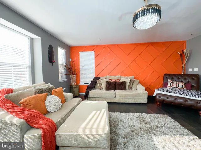 a bedroom with furniture and a large window