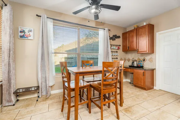 a dining room with furniture and window