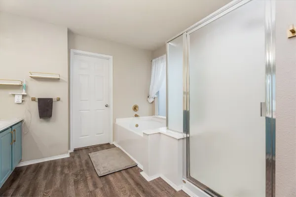 a view of a bathroom with a tub and shower