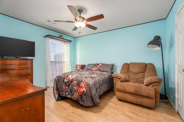 a bedroom with bed and a flat screen tv