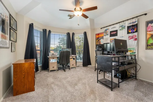a living room with furniture a flat screen tv and a large window