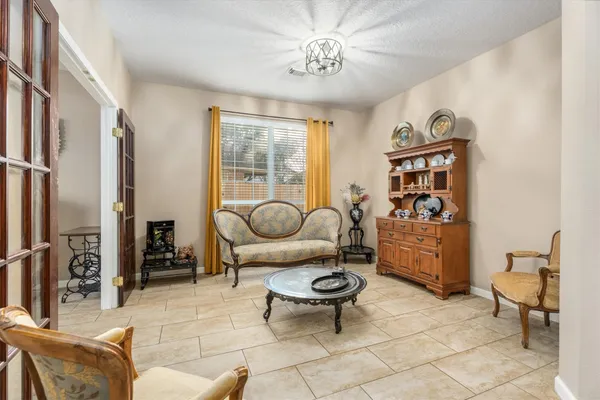 a living room with furniture a rug and a window