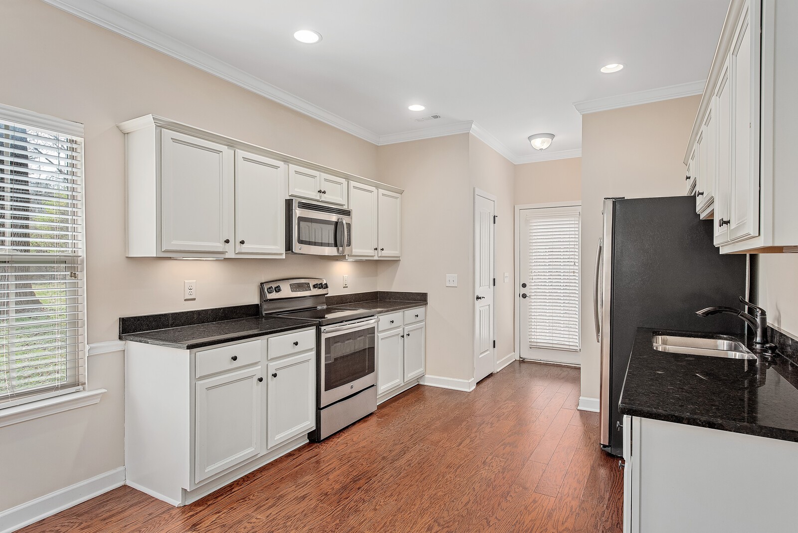 105 Velena Street Franklin, TN 37064 - Photo 13 of 31 a kitchen with granite countertop a refrigerator stove and sink