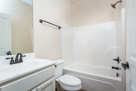 a bathroom with a sink a toilet and a bathtub
