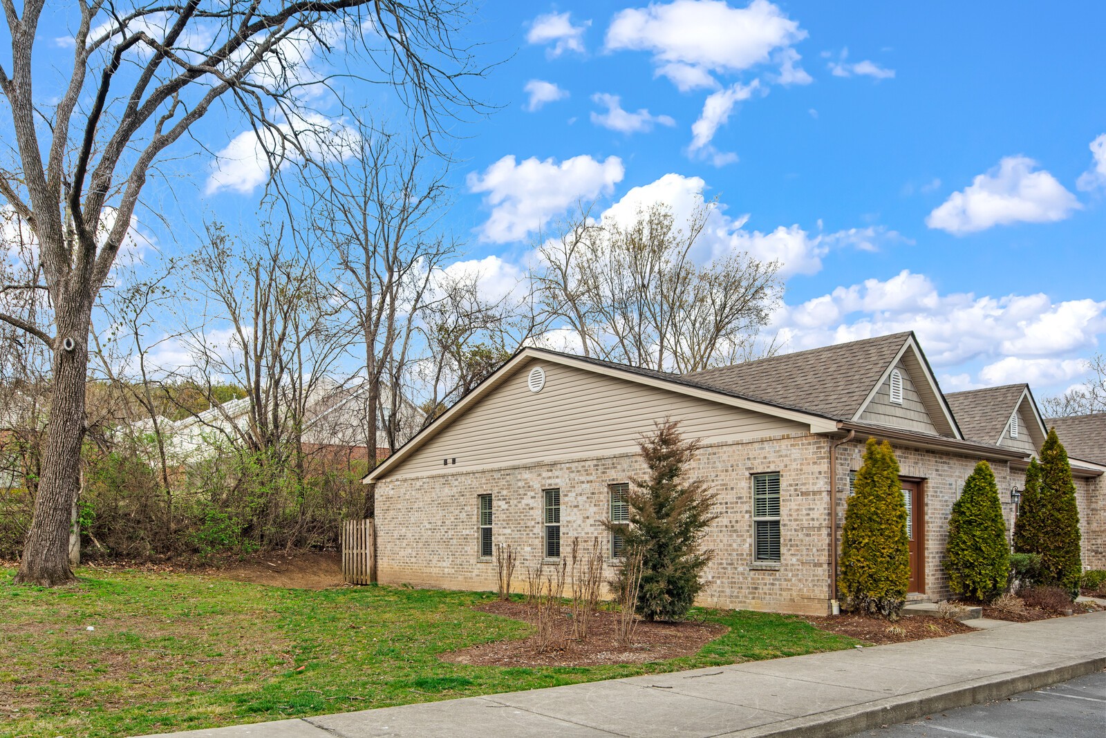 105 Velena Street Franklin, TN 37064 - Photo 31 of 31 a view of a white house next to a yard with big trees