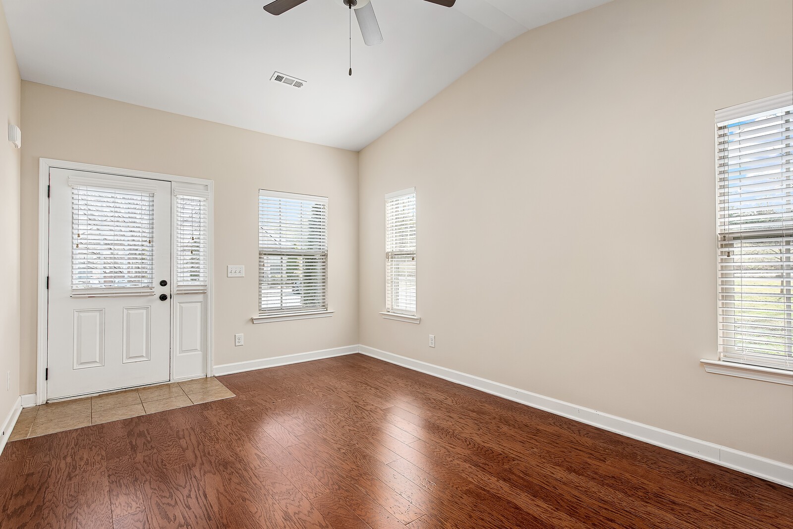 105 Velena Street Franklin, TN 37064 - Photo 7 of 31 a view of an empty room with wooden floor and a window
