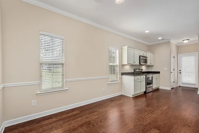 a kitchen with stainless steel appliances a refrigerator sink and cabinets
