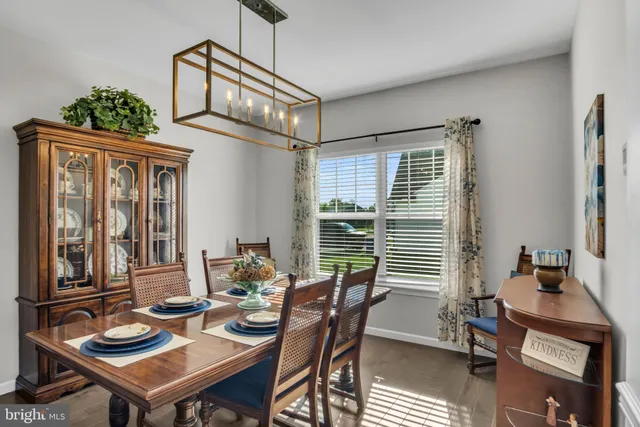 a kitchen with kitchen island granite countertop a sink cabinets and stainless steel appliances