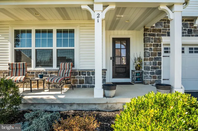 a living room with furniture a dining table and paintings on the wall