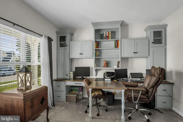 a living room with furniture a rug and a chandelier