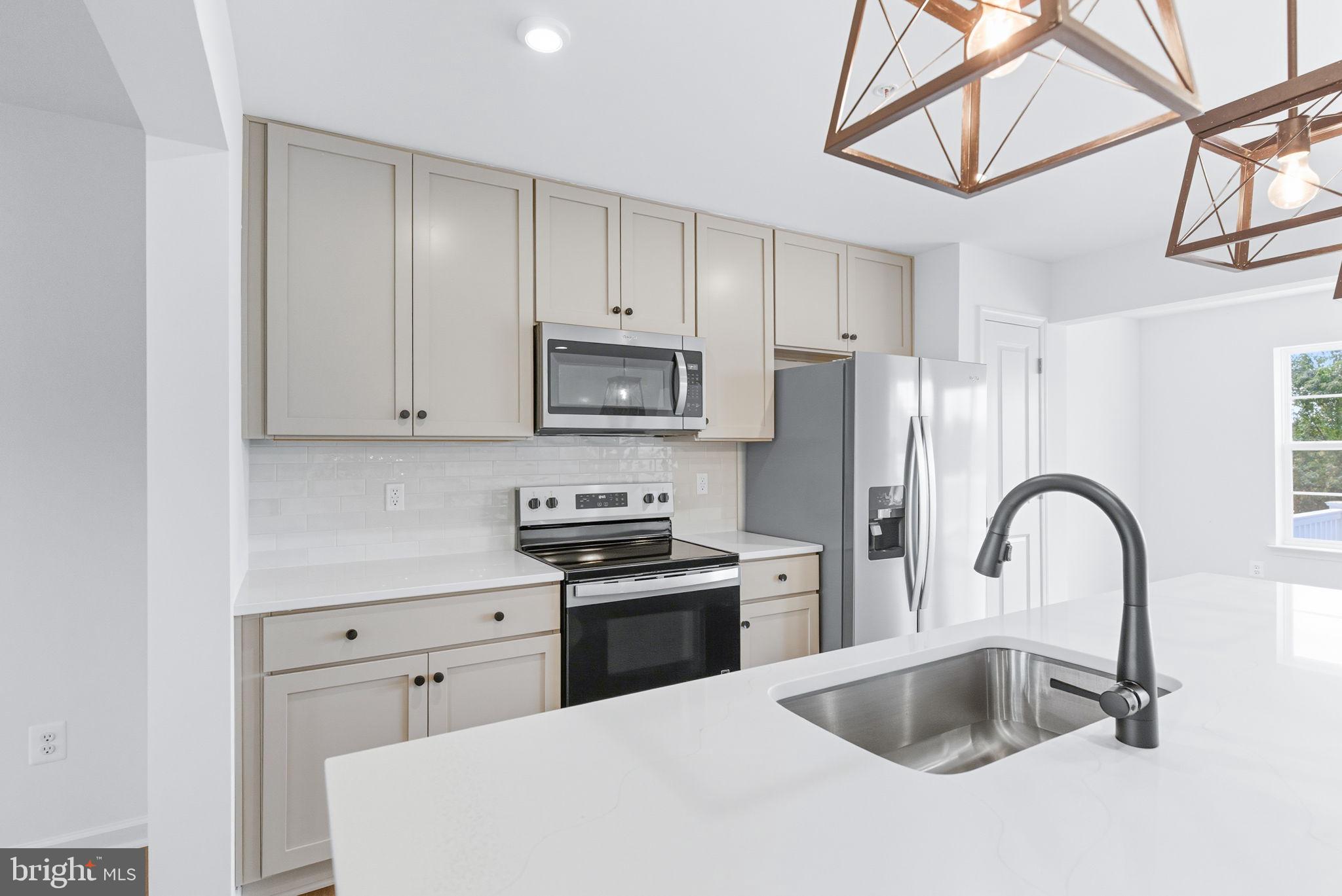 151 Homestead Drive Hanover, PA 17331 - Photo 4 of 46 a kitchen with stainless steel appliances granite countertop a sink stove and refrigerator