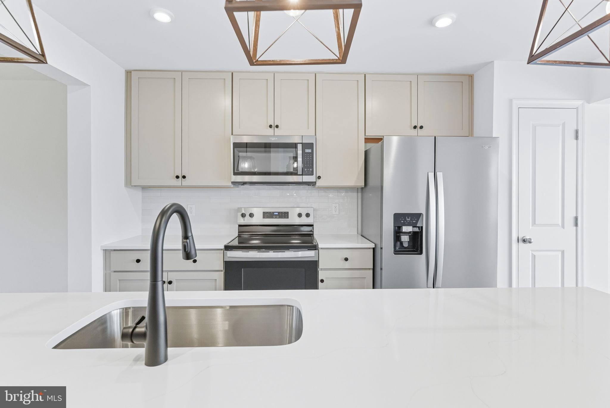151 Homestead Drive Hanover, PA 17331 - Photo 5 of 46 a kitchen with stainless steel appliances granite countertop a refrigerator a stove a sink and white cabinets with a granite countertops