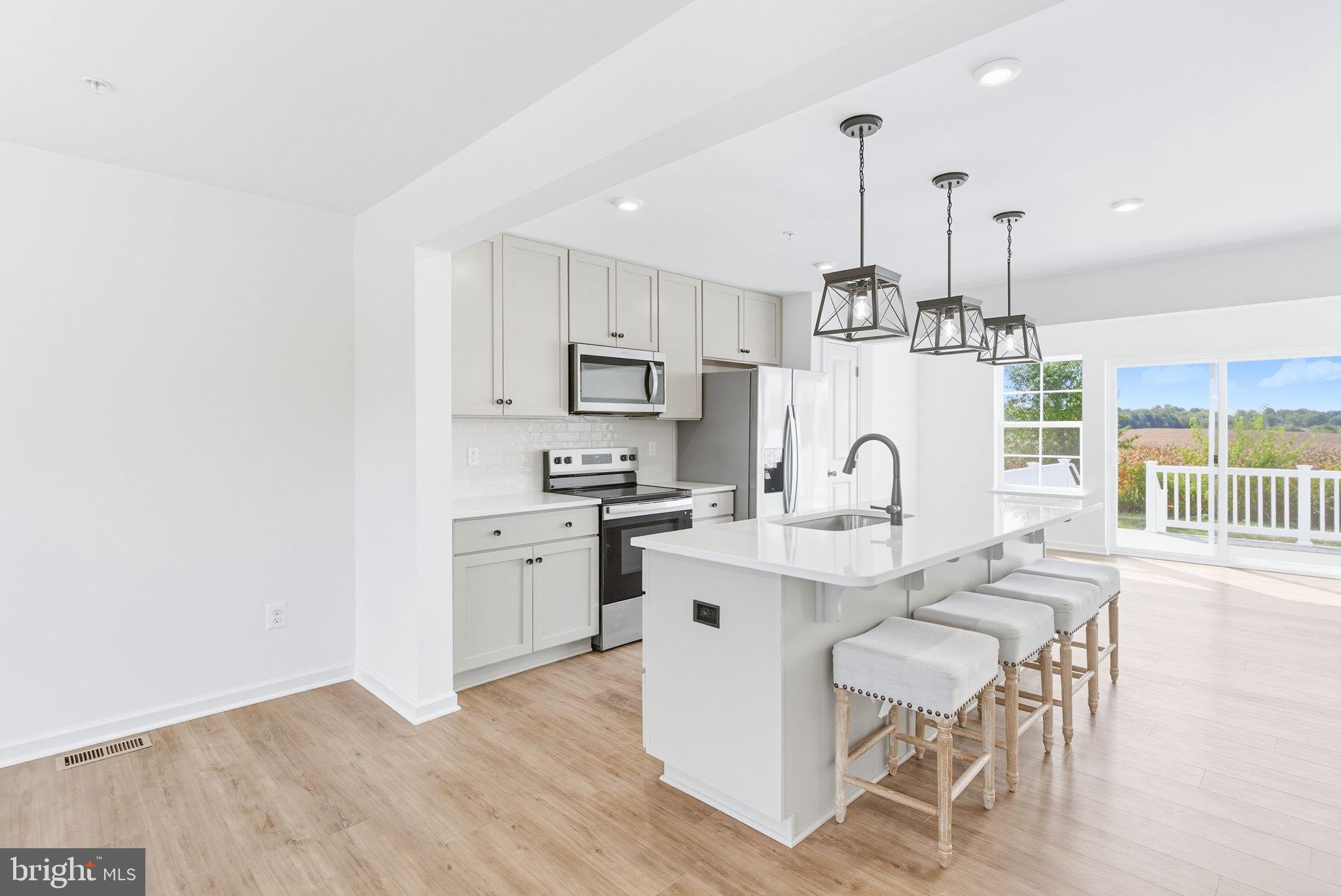 151 Homestead Drive Hanover, PA 17331 - Photo 9 of 46 a kitchen with white cabinets stove and kitchen island