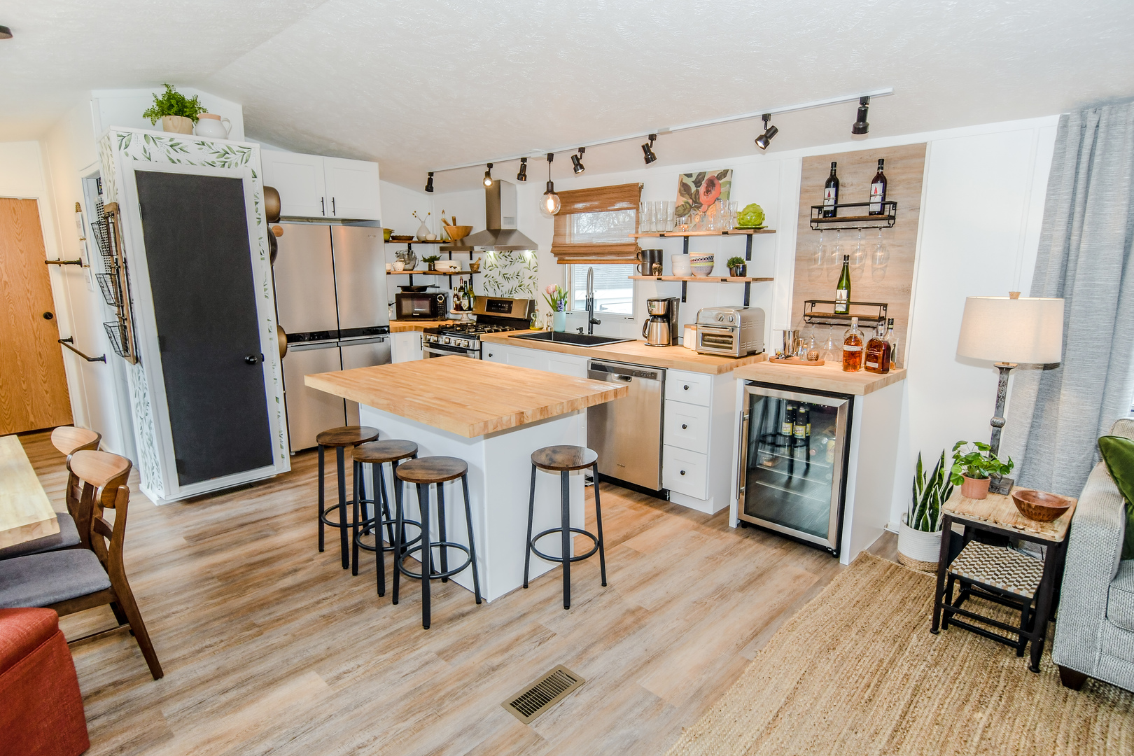 58 Oak Street Minooka, IL 60447 - Photo 6 of 28 a kitchen with stainless steel appliances a dining table chairs refrigerator and sink