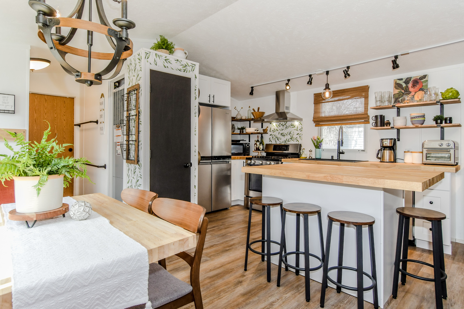 58 Oak Street Minooka, IL 60447 - Photo 7 of 28 a kitchen with stainless steel appliances a dining table chairs and chandelier