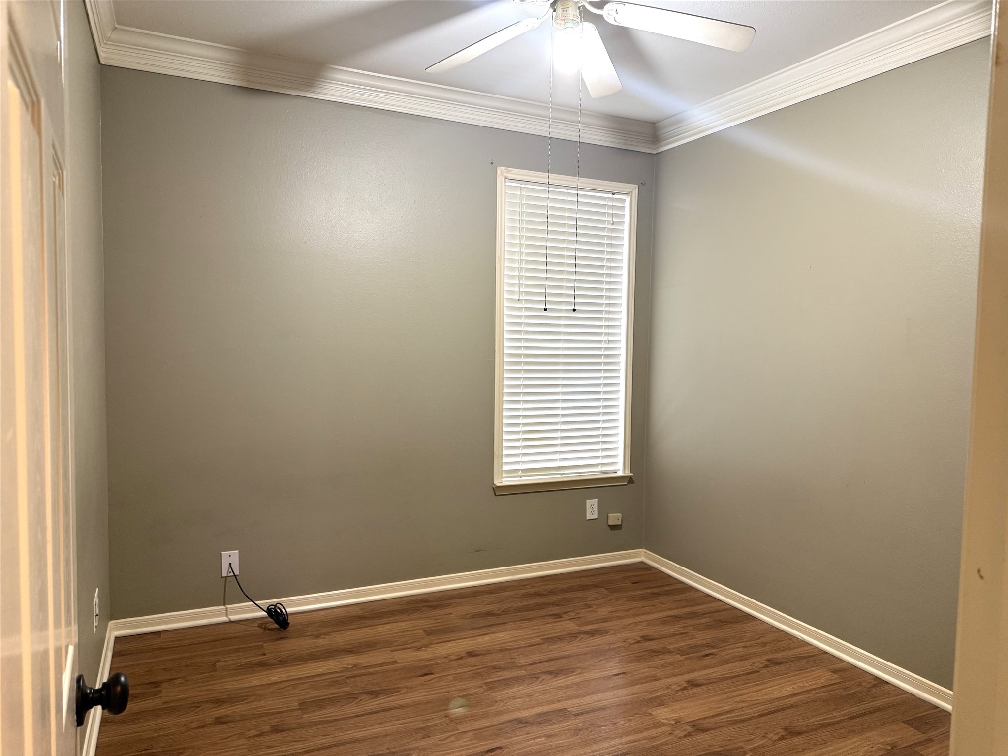 915 Saginaw Bay Court Spring, TX 77373 - Photo 11 of 15 This bedroom features neutral walls, vinyl wood flooring, a window with blinds, and a ceiling fan with lights, offering a clean and versatile space.ideal for a bedroom or office