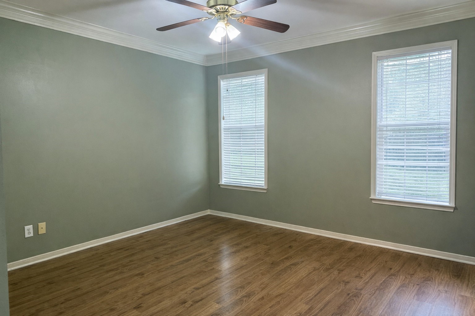 915 Saginaw Bay Court Spring, TX 77373 - Photo 10 of 15 Priminary Bedrm. This room features vinyl floors, olive green walls with white trim, walk in closet and ensuite. A ceiling fan with lights provides overhead illumination. The space is bright and open, ideal for a bedroom or office
