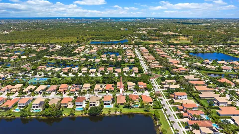 an aerial view of residential houses with outdoor space and lake view