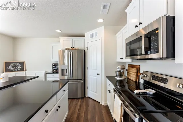 a kitchen with a refrigerator stove and microwave