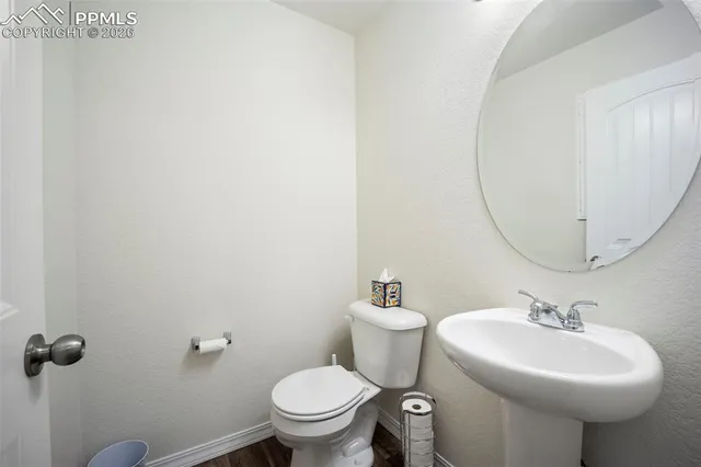 a bathroom with a sink toilet and a mirror