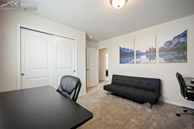 a living room with furniture and a painting