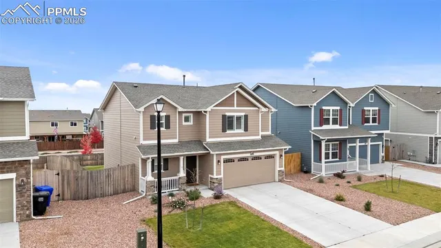 an aerial view of residential houses with outdoor space and ocean view
