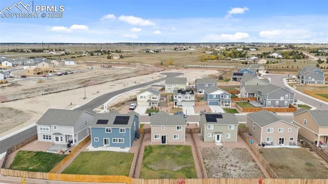 an aerial view of a house with a yard and balcony