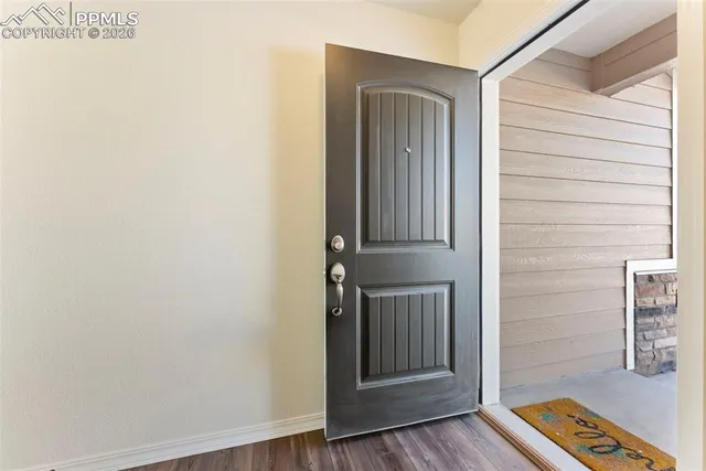a view of front door with wooden floor