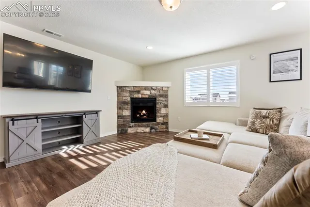 a bedroom with furniture or flat screen tv and a fireplace