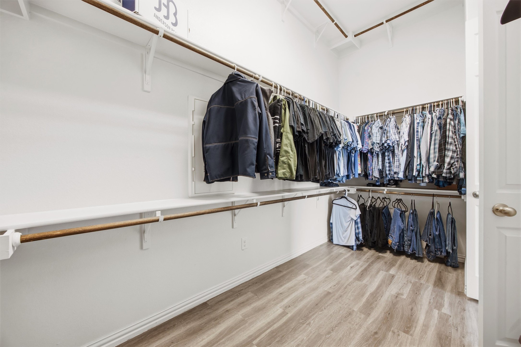 192 Raptor Beak Way Cedar Creek, TX 78612 - Photo 20 of 38 Walk-in closet featuring light wood-finish flooring, white walls, and multiple levels of shelving and hanging rods