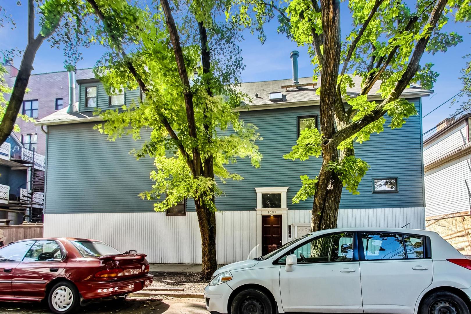 1009 West Wolfram Street, Unit 2W Chicago, IL 60657 - Photo 1 of 24 a front view of a house with car parked