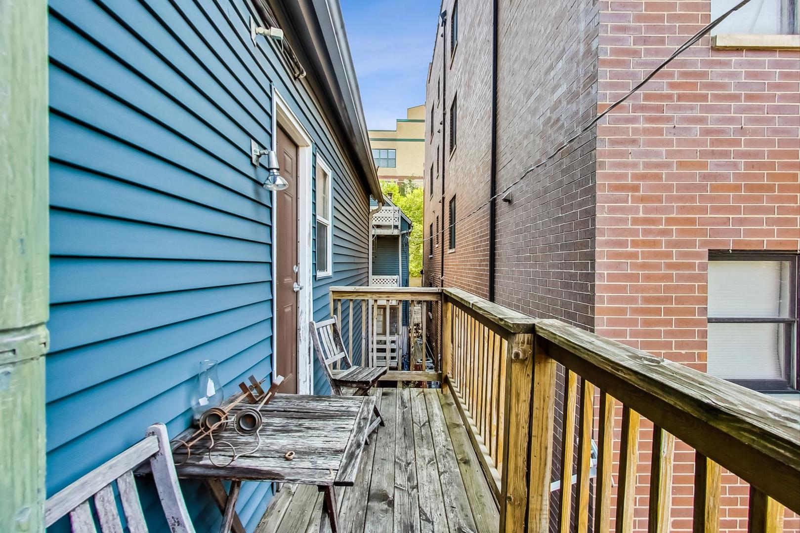 1009 West Wolfram Street, Unit 2W Chicago, IL 60657 - Photo 14 of 24 a view of balcony with wooden floor and stairs