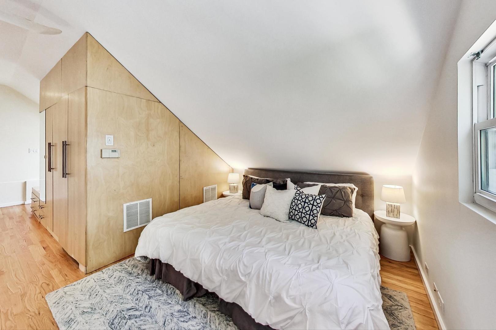 1009 West Wolfram Street, Unit 2W Chicago, IL 60657 - Photo 19 of 24 a bedroom with a large bed and a rug