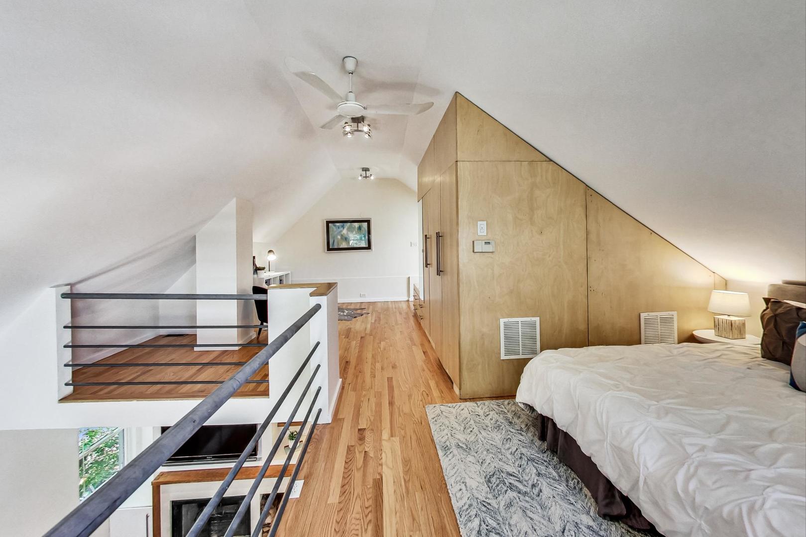 1009 West Wolfram Street, Unit 2W Chicago, IL 60657 - Photo 20 of 24 a spacious bedroom with a bed and wooden floor