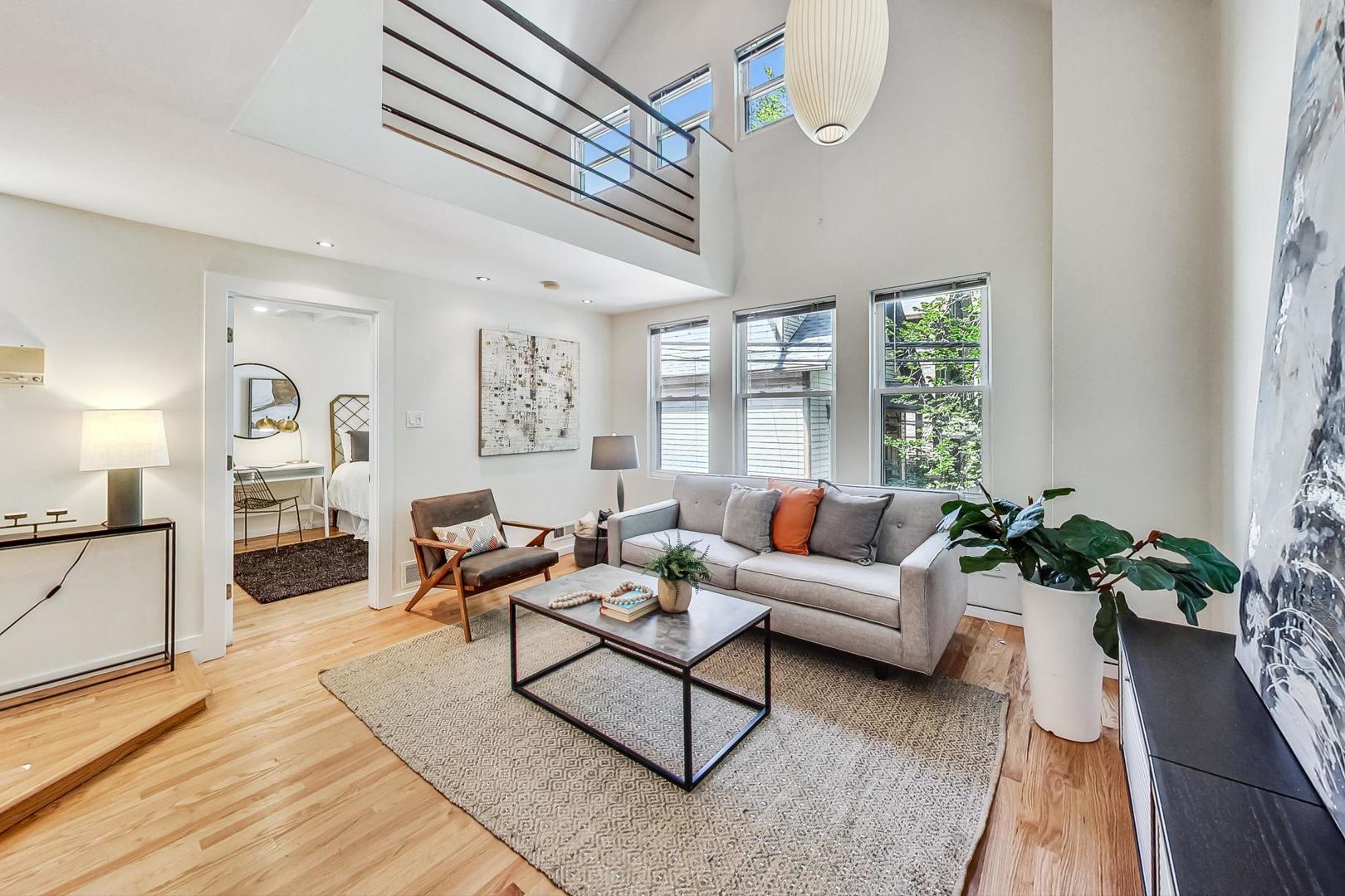 1009 West Wolfram Street, Unit 2W Chicago, IL 60657 - Photo 5 of 24 a living room with furniture and a potted plant