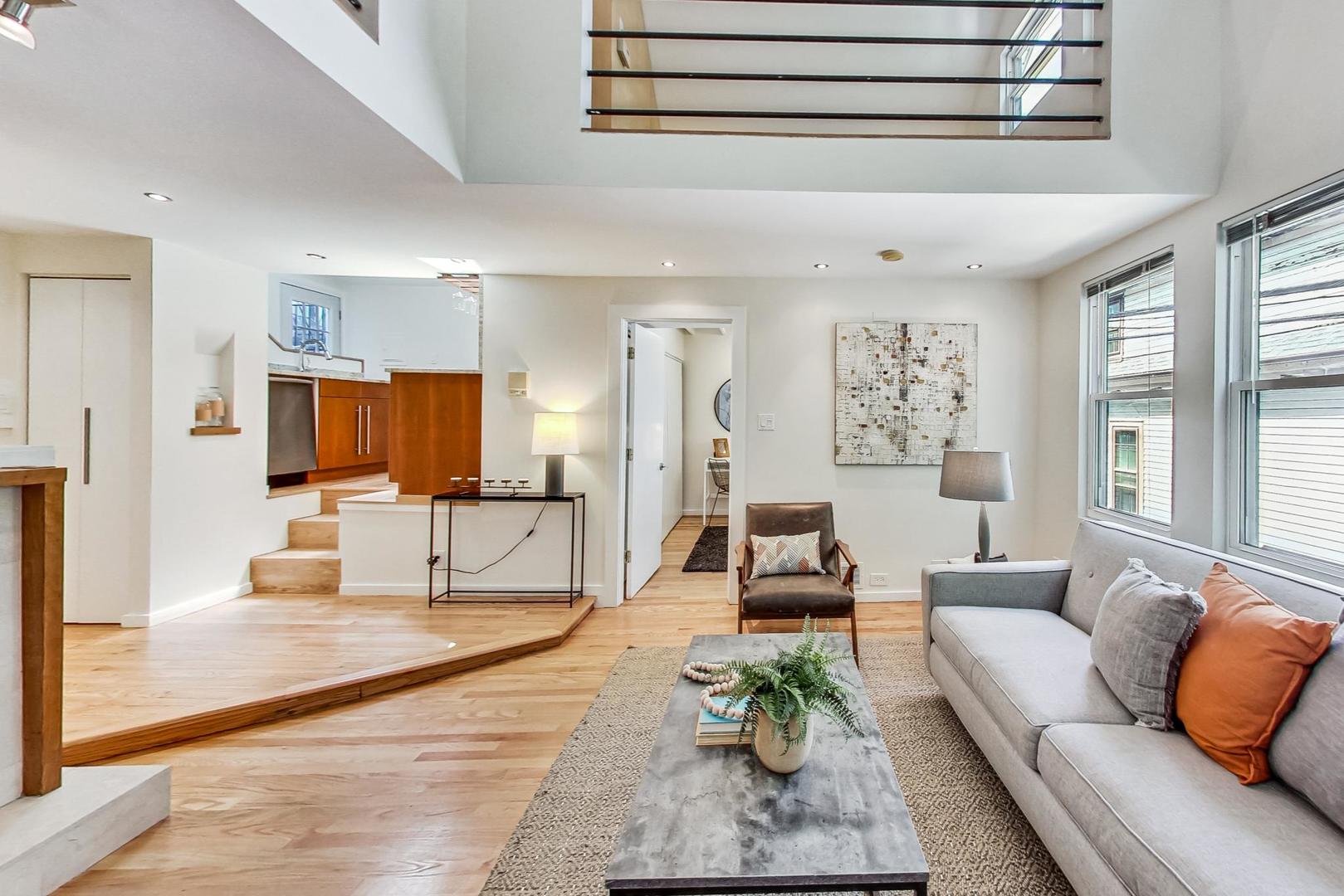 1009 West Wolfram Street, Unit 2W Chicago, IL 60657 - Photo 6 of 24 a living room with furniture and a large window