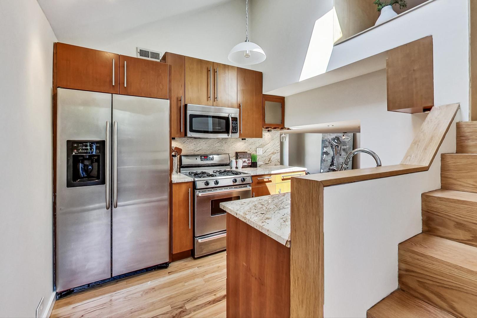 1009 West Wolfram Street, Unit 2W Chicago, IL 60657 - Photo 8 of 24 a kitchen with stainless steel appliances granite countertop a refrigerator a stove a sink and a refrigerator