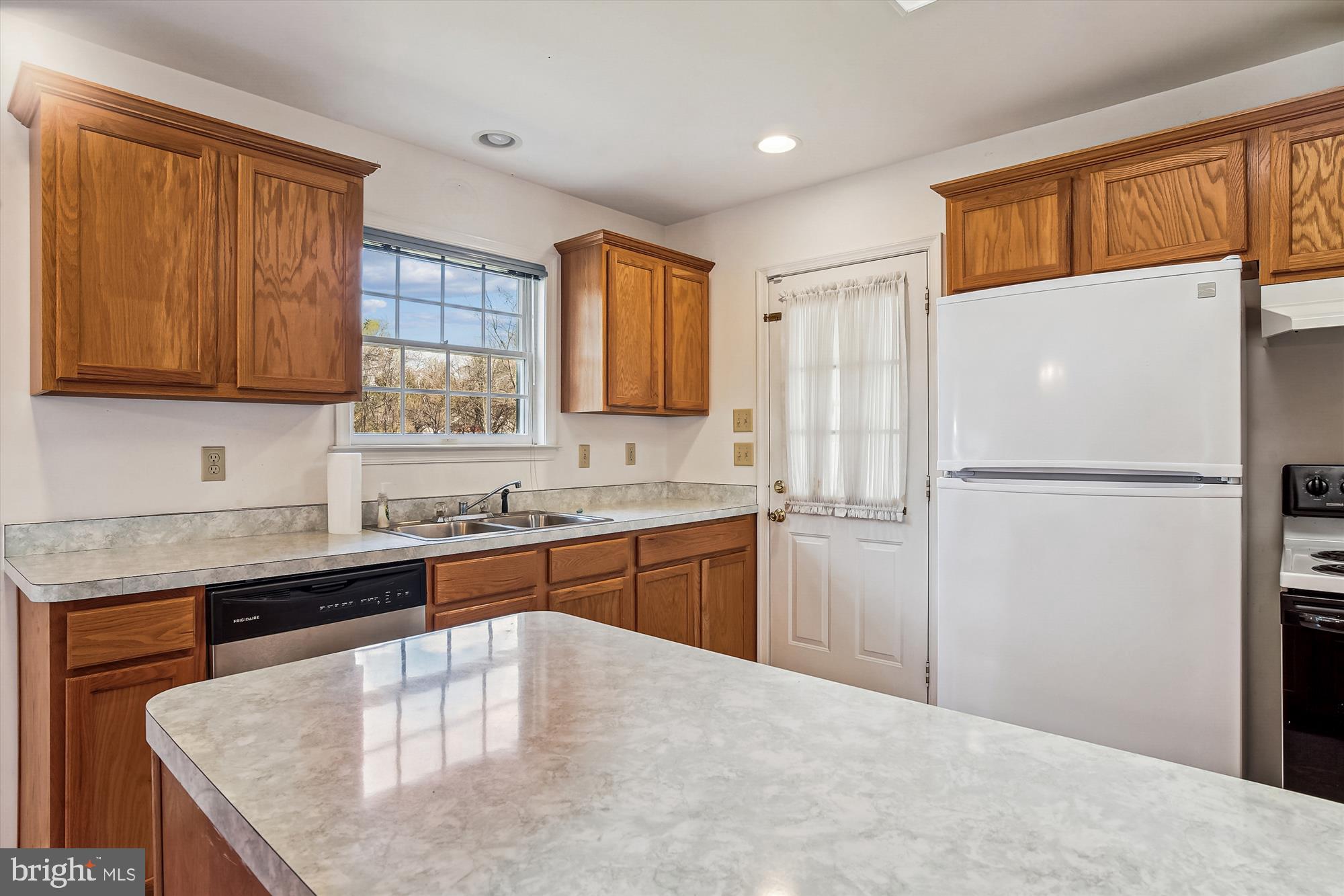 130 Sheaffer Road Chestertown, MD 21620 - Photo 5 of 25 a kitchen with stainless steel appliances granite countertop a refrigerator a sink dishwasher a stove with wooden cabinets and floor
