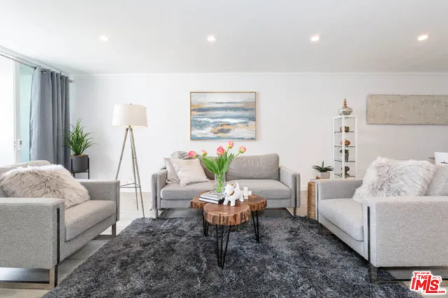 a living room with furniture and a large mirror