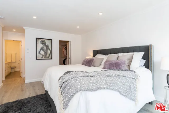 a large bed sitting in a bedroom and a table