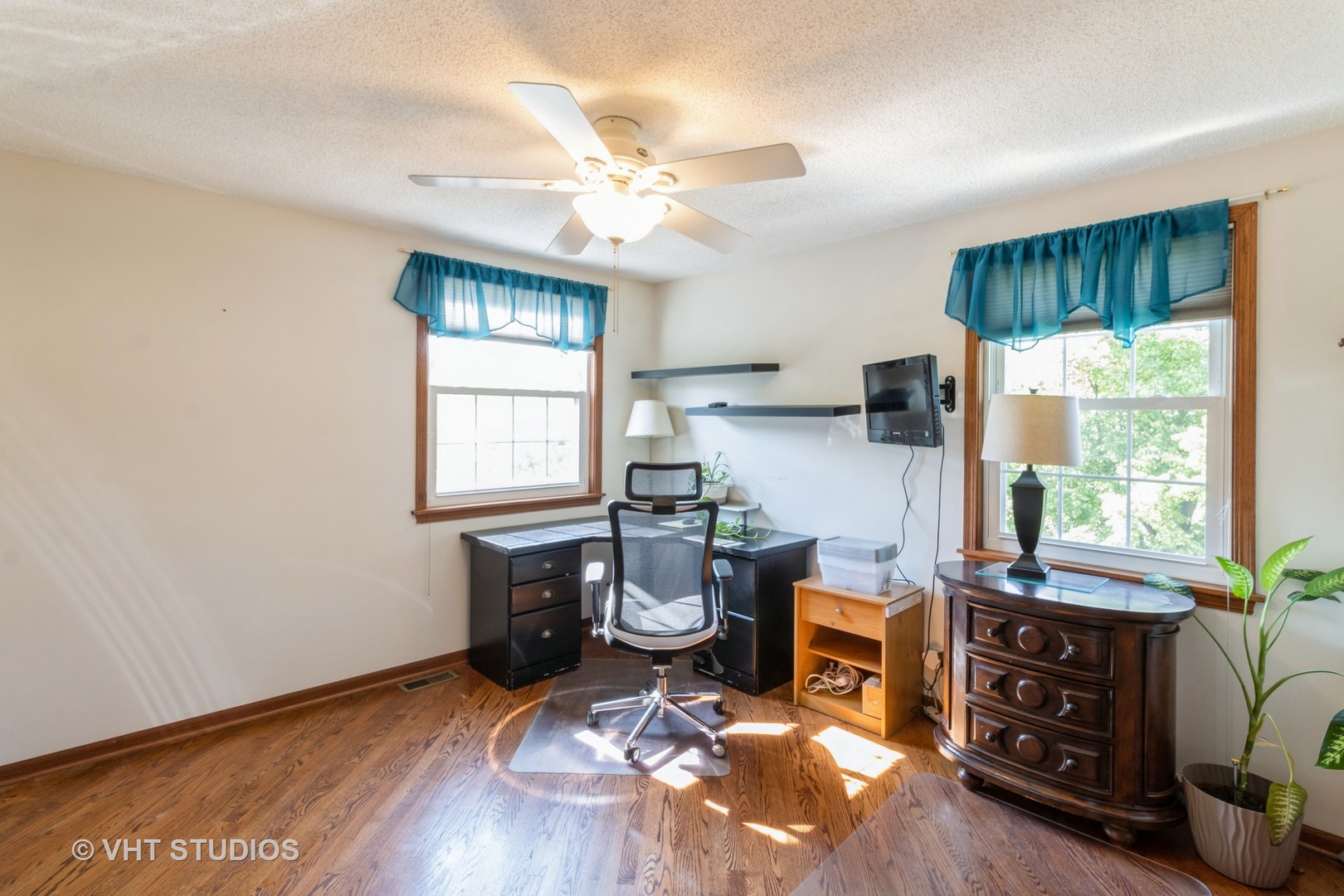 1061 Warwick Circle North Hoffman Estates, IL 60169 - Photo 13 of 18 a room with furniture a window and wooden floor