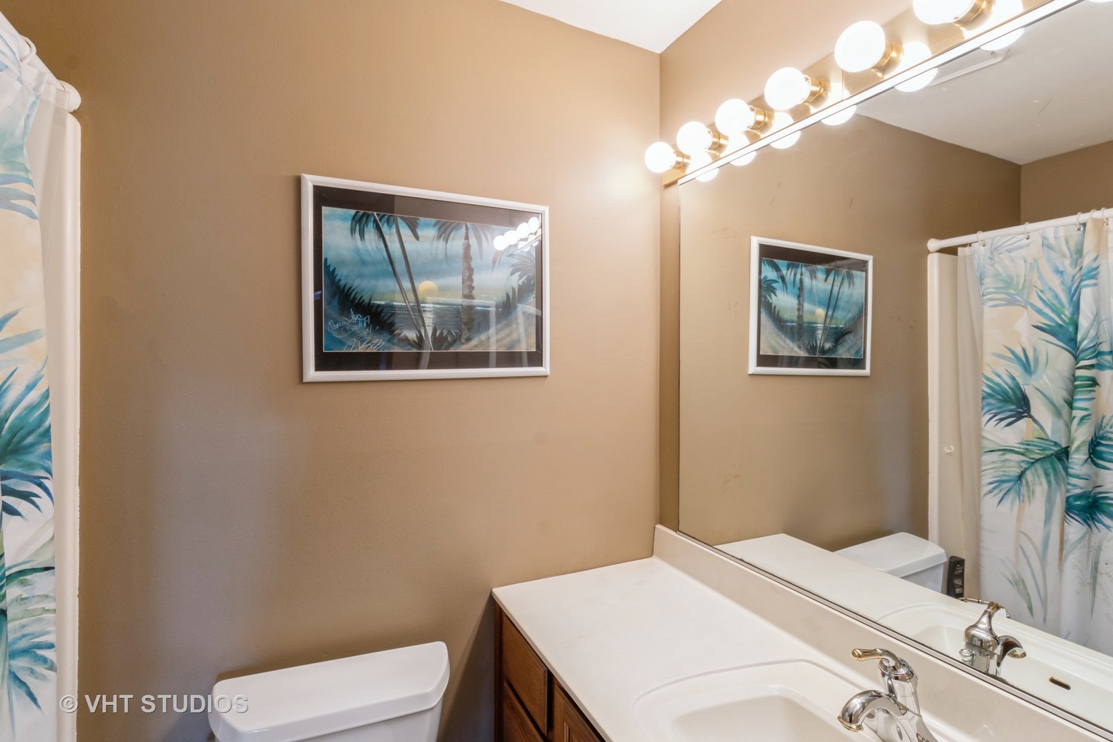 1061 Warwick Circle North Hoffman Estates, IL 60169 - Photo 16 of 18 a bathroom with a toilet a sink and a mirror