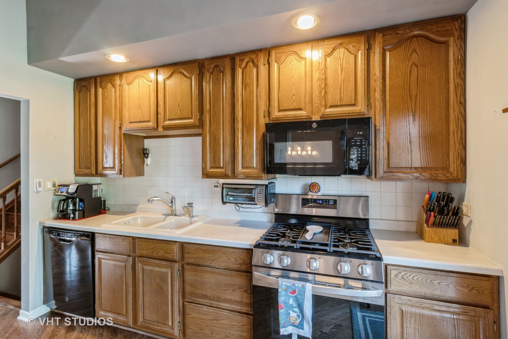 1061 Warwick Circle North Hoffman Estates, IL 60169 - Photo 8 of 18 a kitchen with a stove a sink and a refrigerator