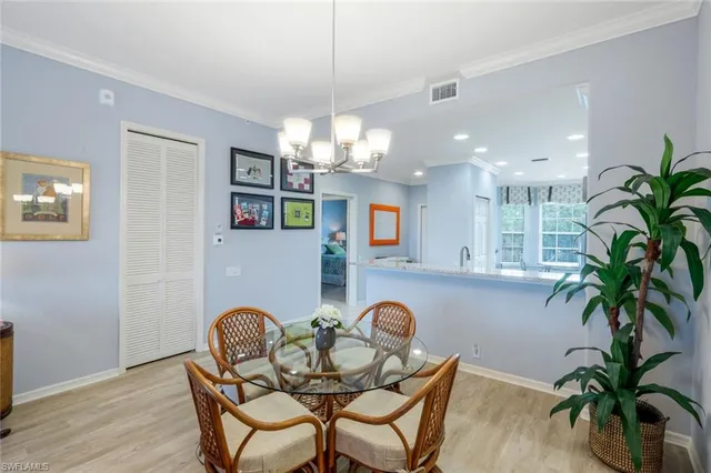 a dining room with furniture and chandelier