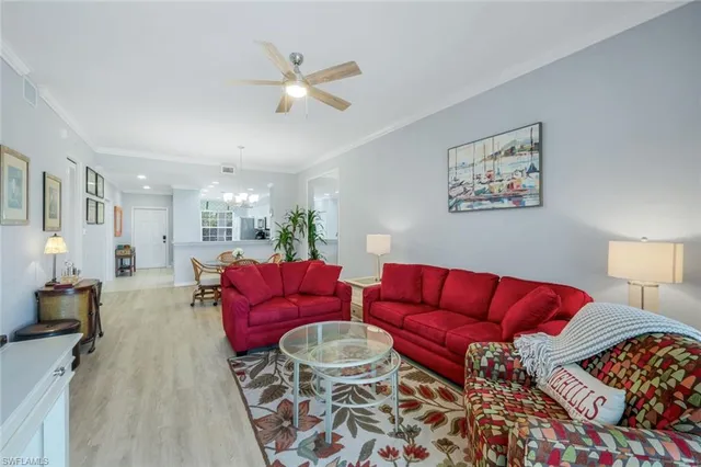 a living room with furniture and a lamp