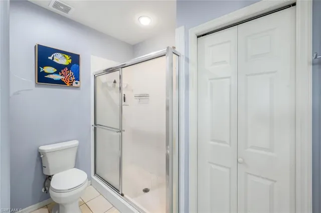 a white toilet sitting next to a bathroom