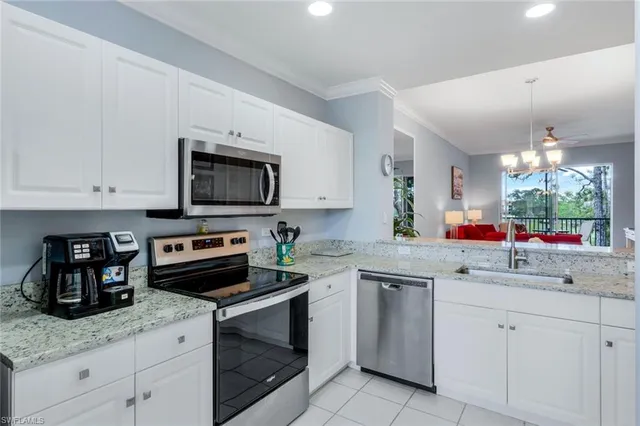 a kitchen with white cabinets and appliances